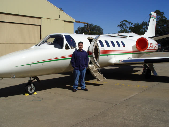 Matt standing beside a Cessna Citation II jet
